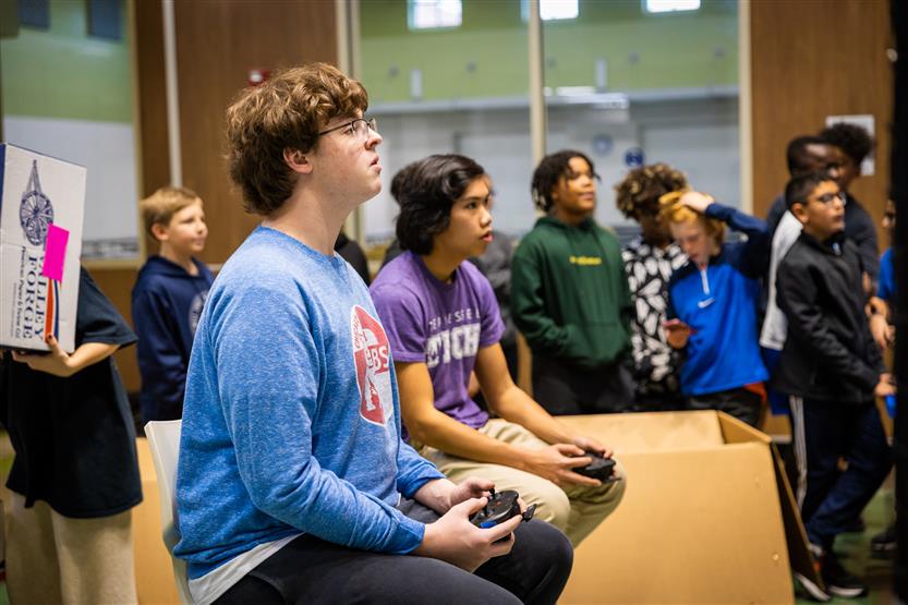 Middle and high school students learning about drone soccer